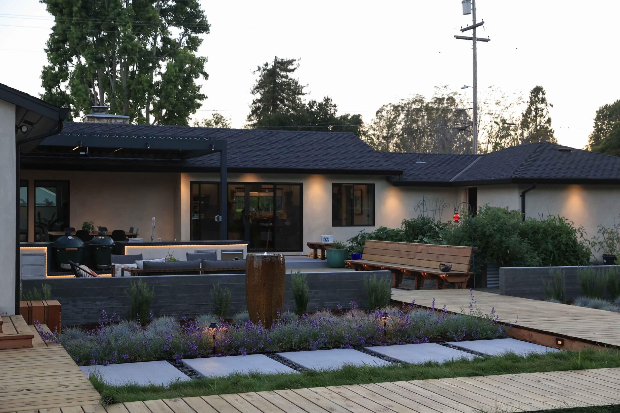 Residential garden space with layered plantings and landscape details by K&D Landscaping