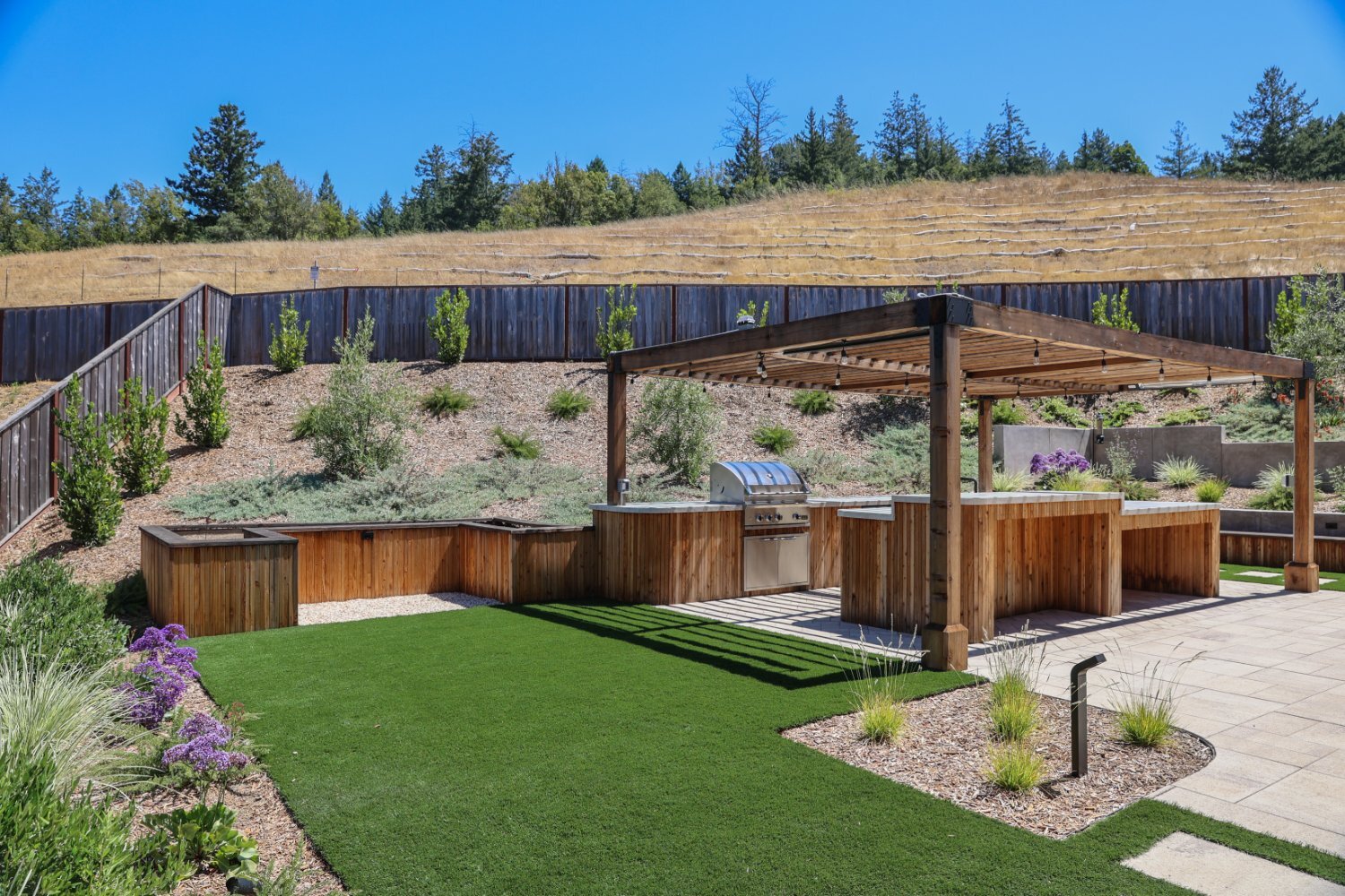 Residential hillside garden featuring custom drainage and planting solutions by K&D Landscaping