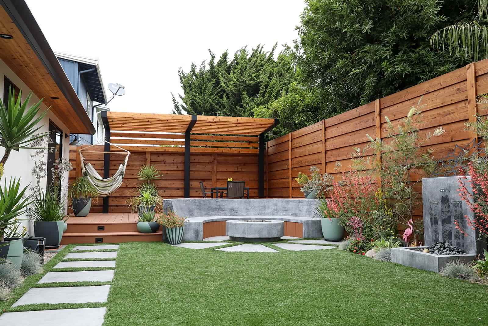 Residential landscape combining hardscape, outdoor living, and custom architectural features by K&D Landscaping