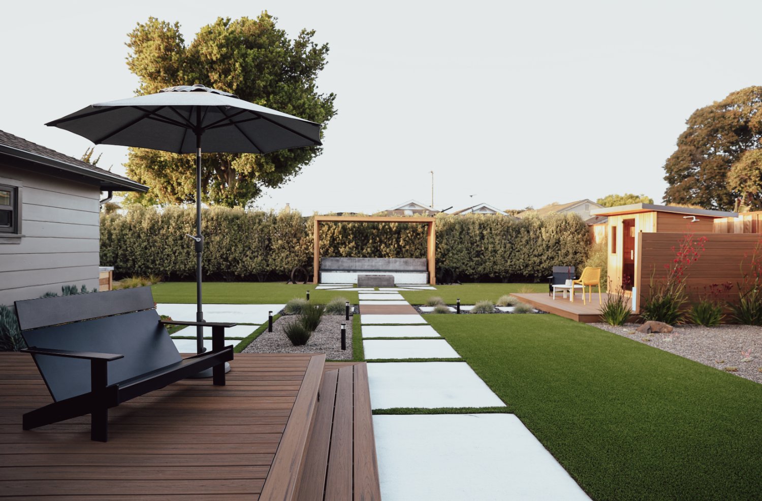 Residential outdoor space featuring edible plantings and functional garden areas by K&D Landscaping