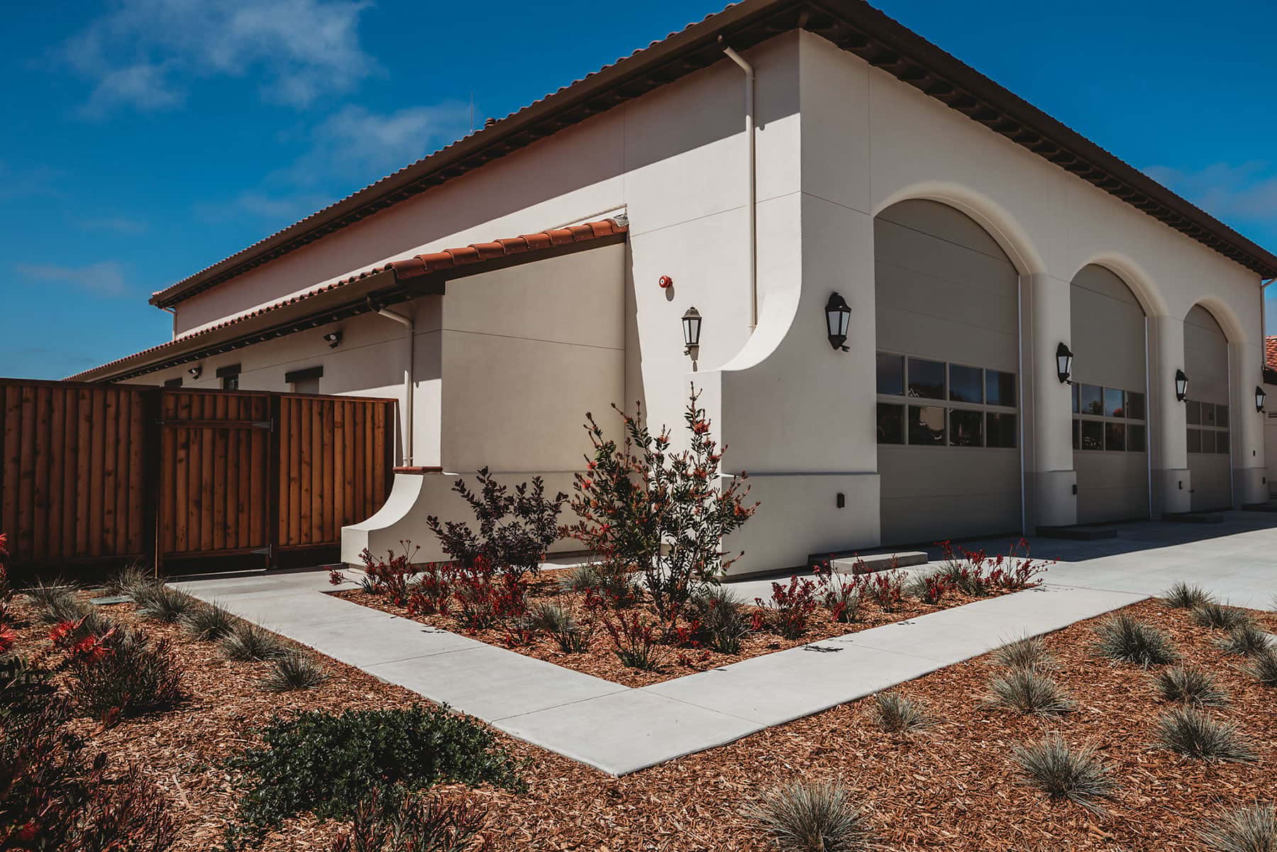 Spanish colonial municipal building with arched openings surrounded by desert landscape design by K&D Landscaping