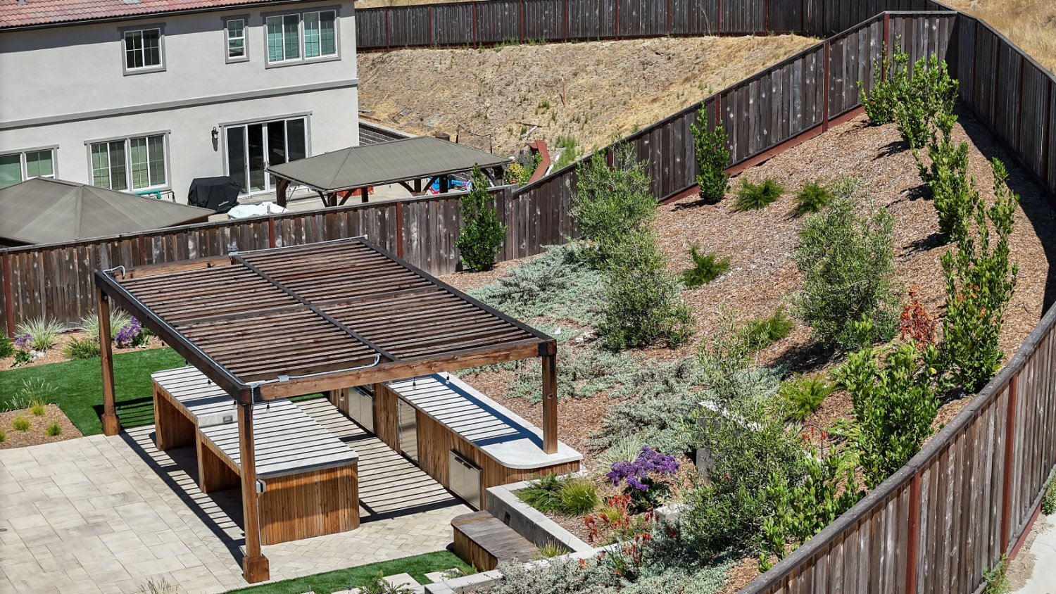 Structural concrete installation supporting a multi-level backyard by K&D Landscaping