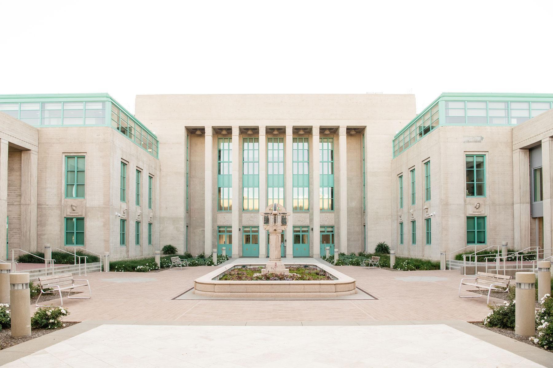 Wide view of government building courtyard with central planter, symmetrical paving, and landscape design completed by K&D Landscaping
