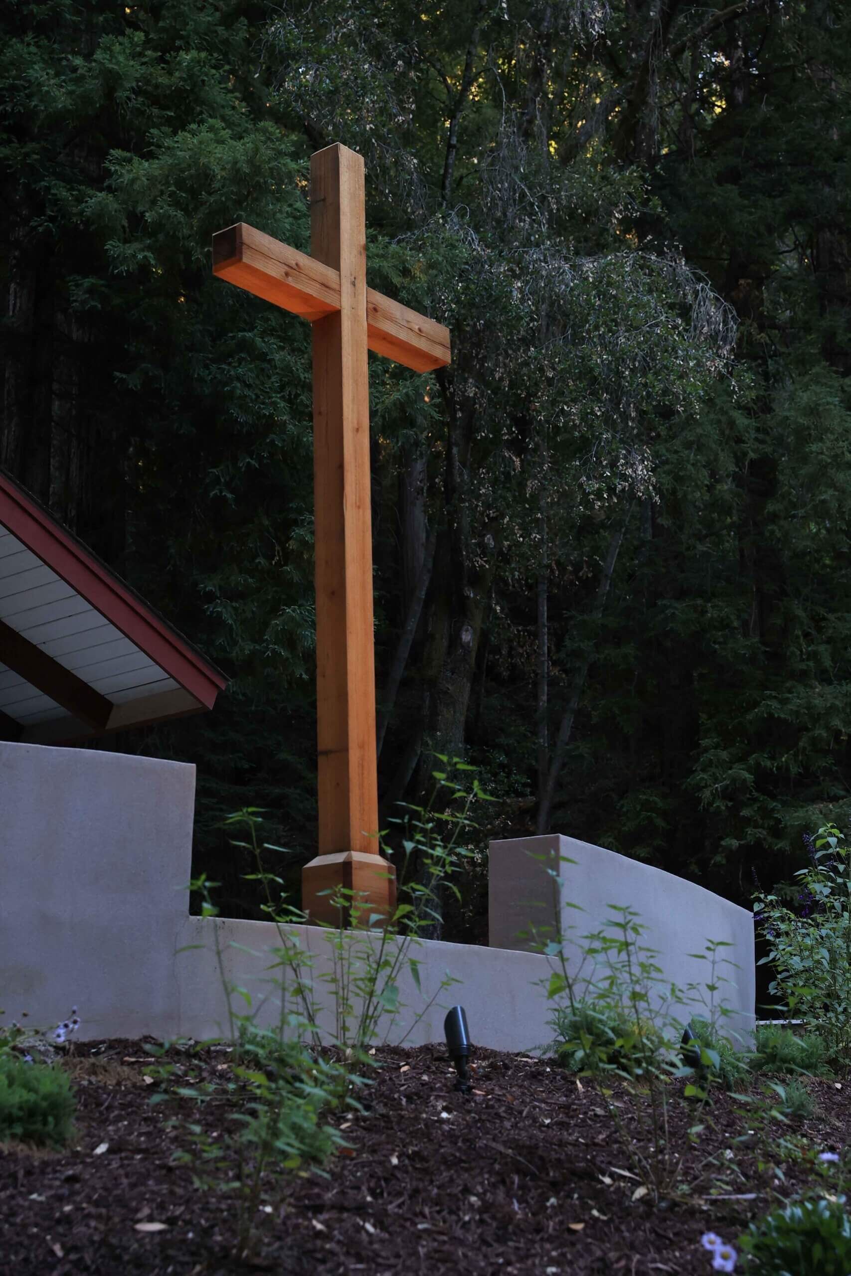 Wooden cross integrated into a natural woodland landscape and gathering space by K&D Landscaping